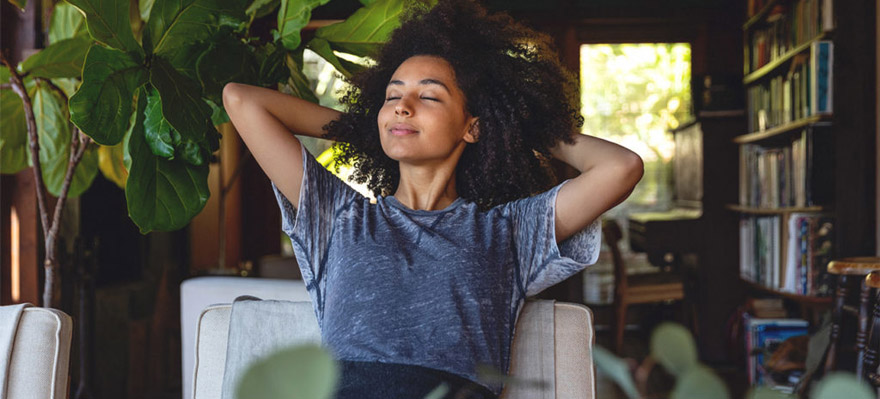 A woman practicing a breathing exercise.